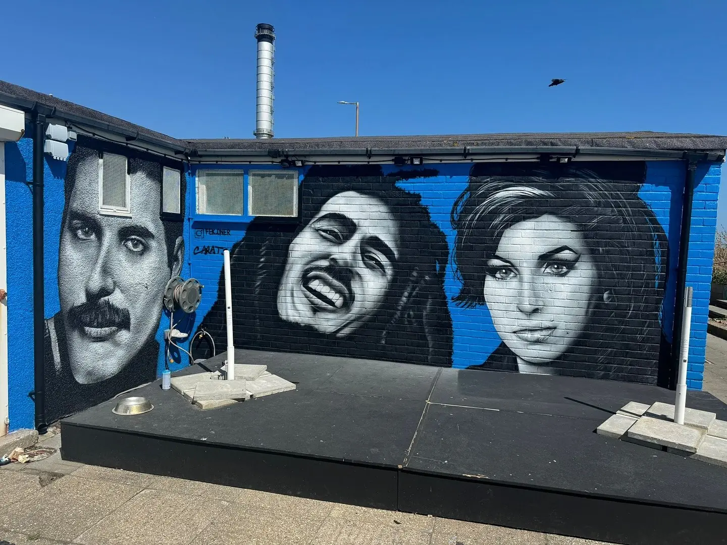 The outdoor stage, painted with murals of Freddie Mercury, Bob Marley and Amy Winehouse